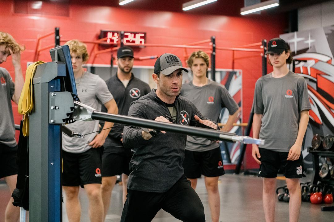 Andy O'Brien demonstrating an exercise to a group of athletes at Quartexx Camp