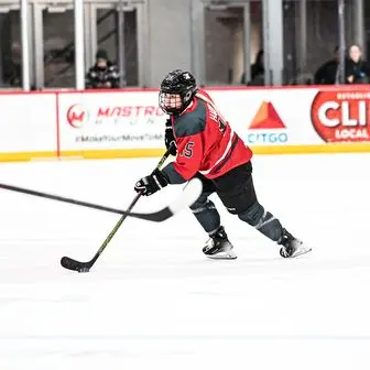 Savannah Harmon carrying the puck in her PWHL Ottawa jersey